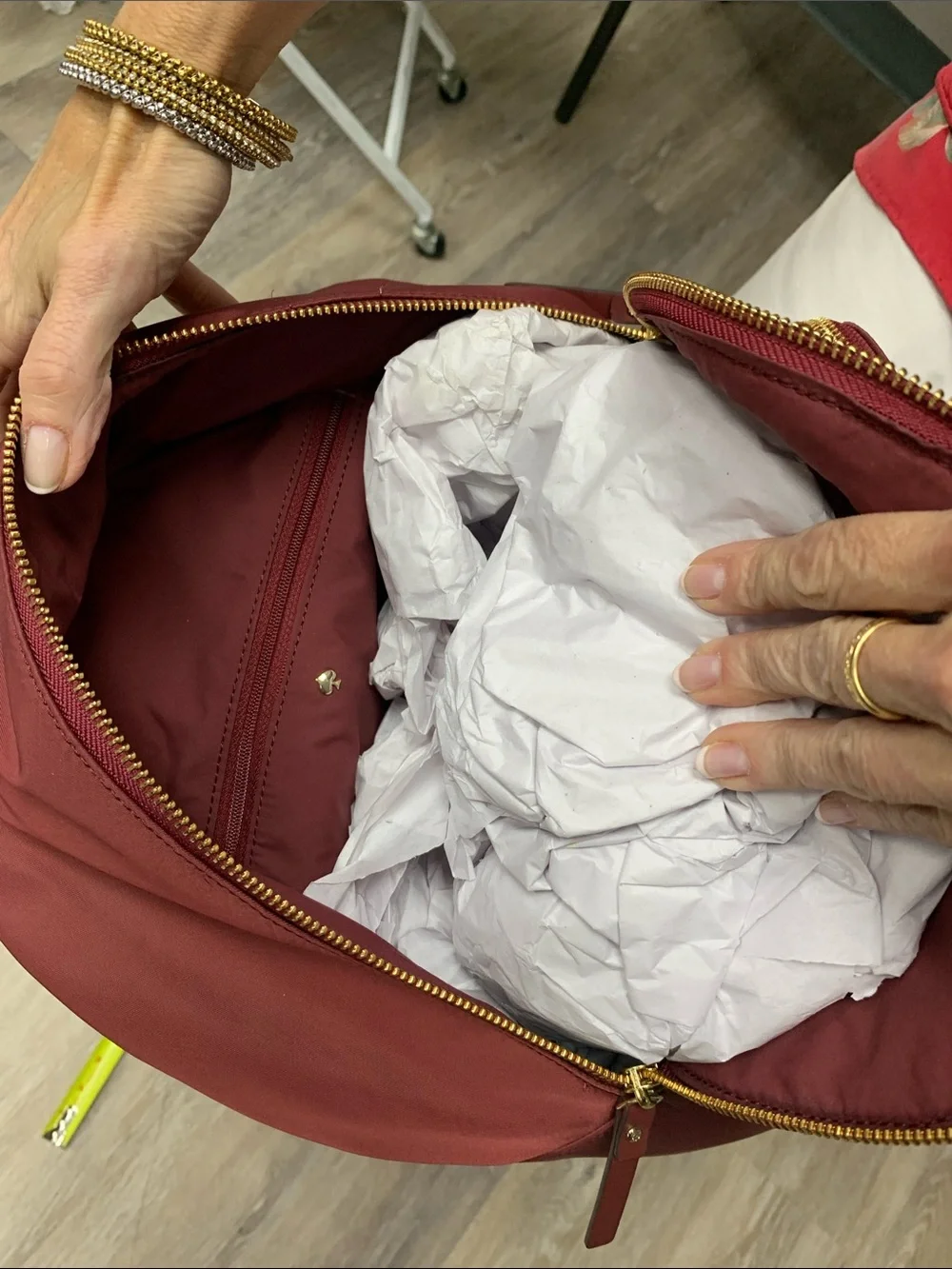 kate spade burgundy nylon backpack with gold-tone accents